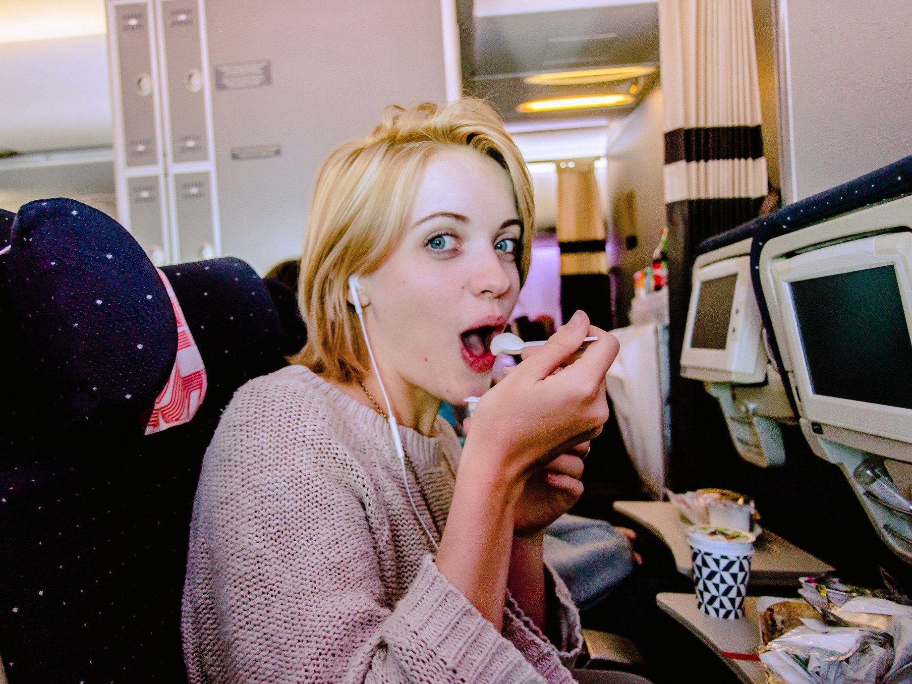 woman-eating-yogurt-on-plane